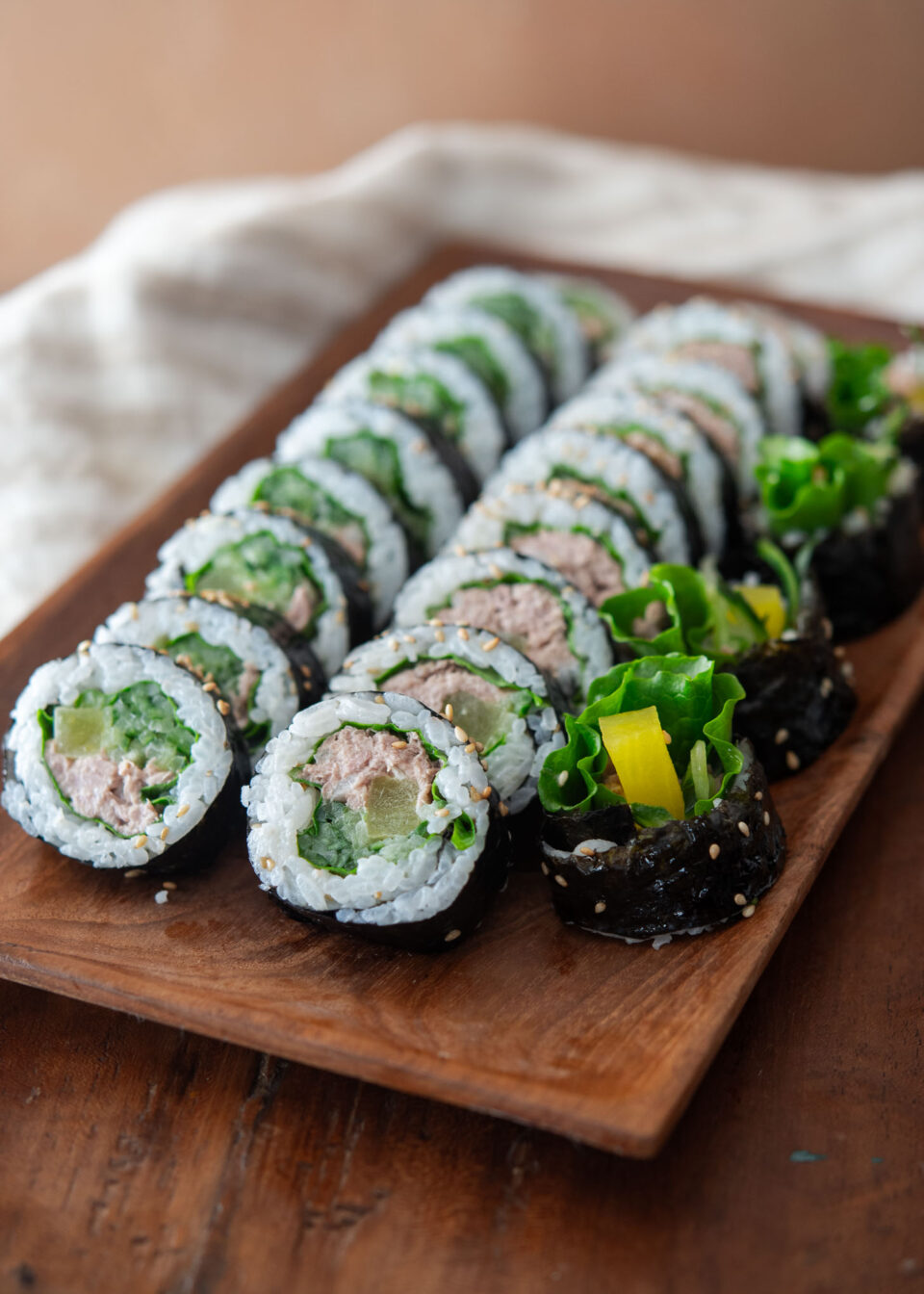 Tuna kimbap slices on a serving platter.