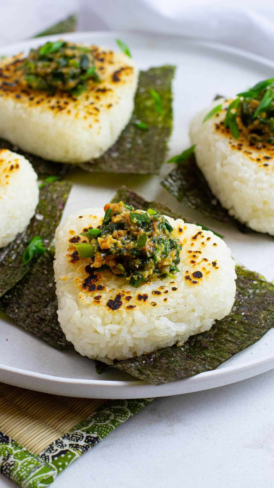 Close up shot of yaki onigiri with miso scallion paste topping.