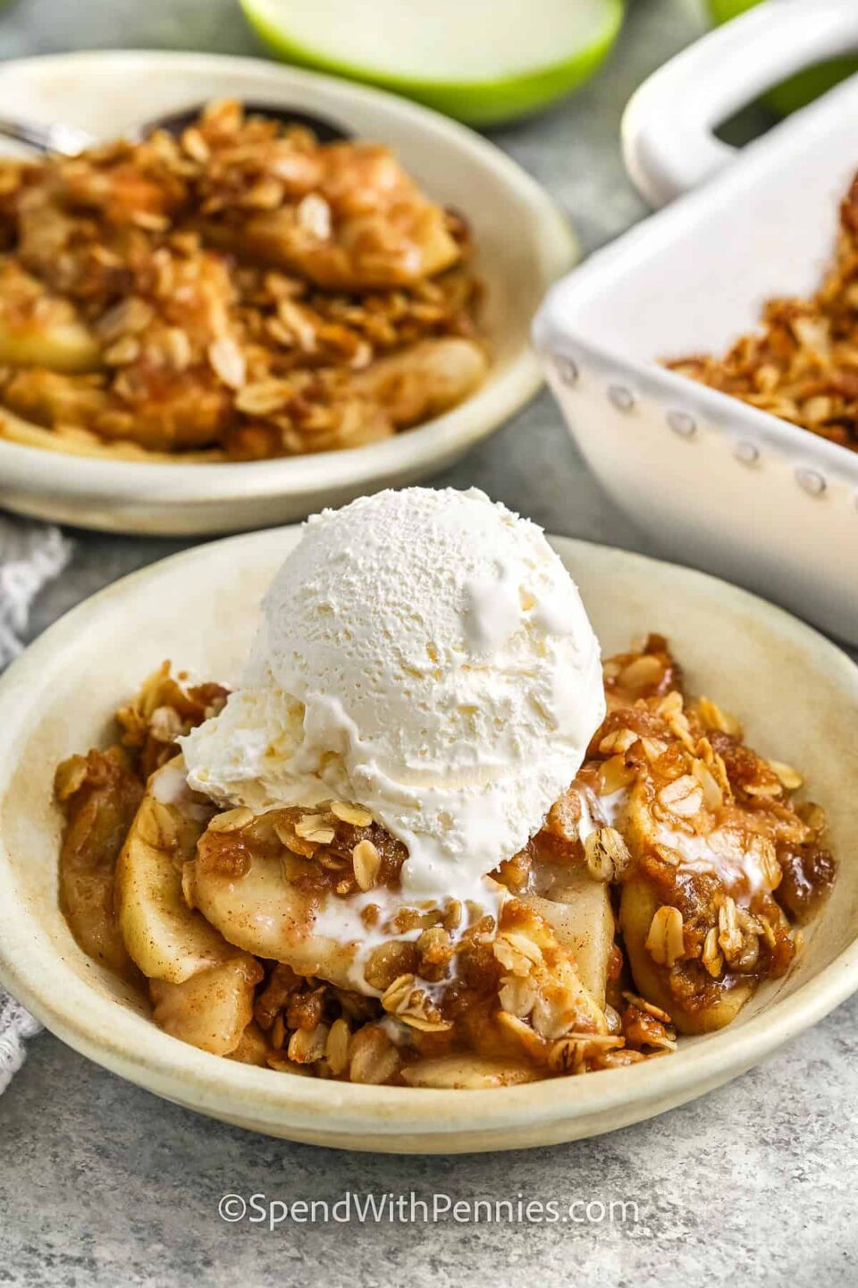 plated dishes of Apple Crisp Recipe with ice cream scoop on top