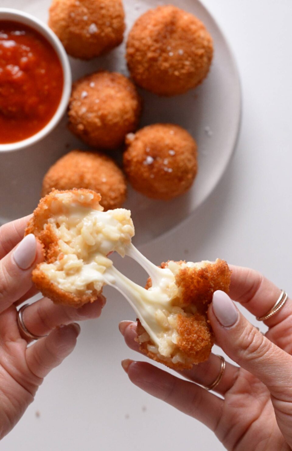 Pulling apart a ball of arancini.