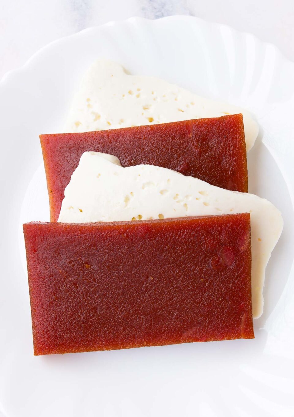 slices of guava and cheese on a white plate