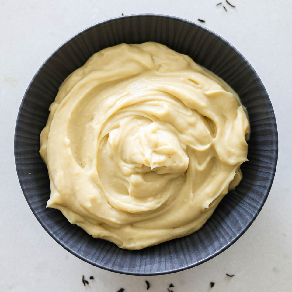 Earl Grey custard in a black bowl.