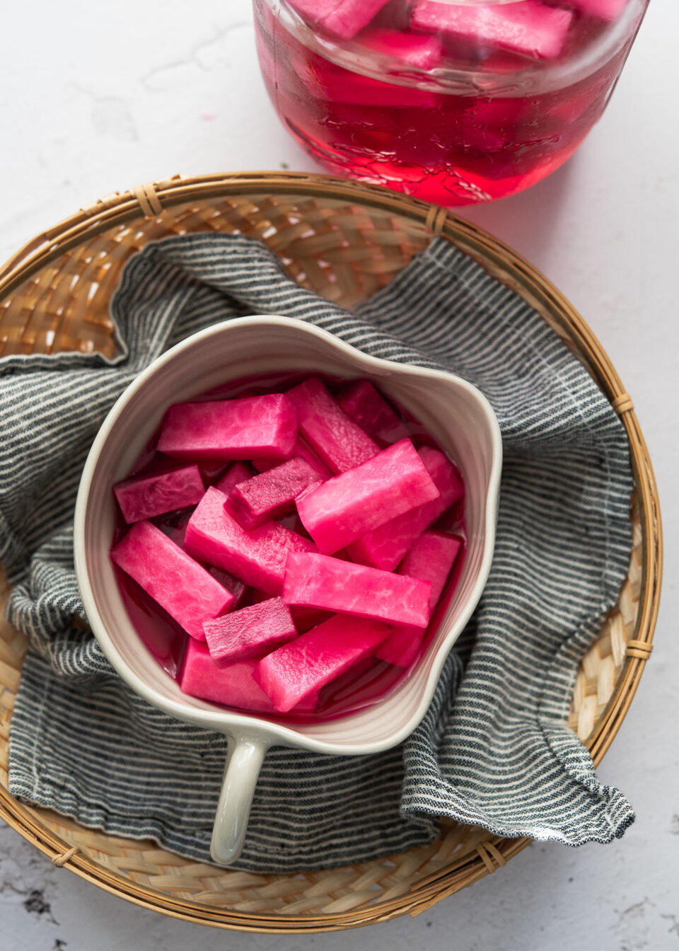 Pink pickled radish in a serving dish.