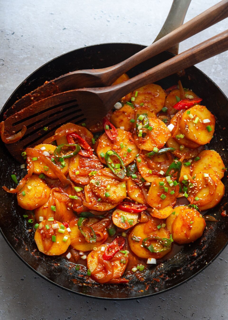 Spicy potatoes braised in a skillet.