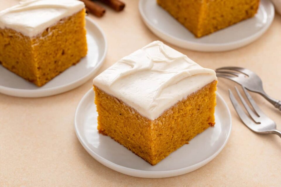 Slice of pumpkin cake on a white plate.